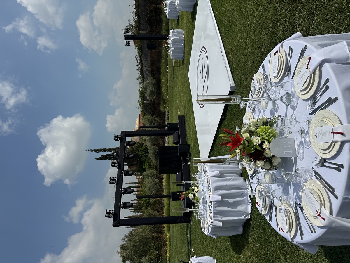 How Much Does a Luxury Agafay Desert Wedding Cost? evening ambiance celebration - A romantic bridal couple walking hand-in-hand across the stony Agafay